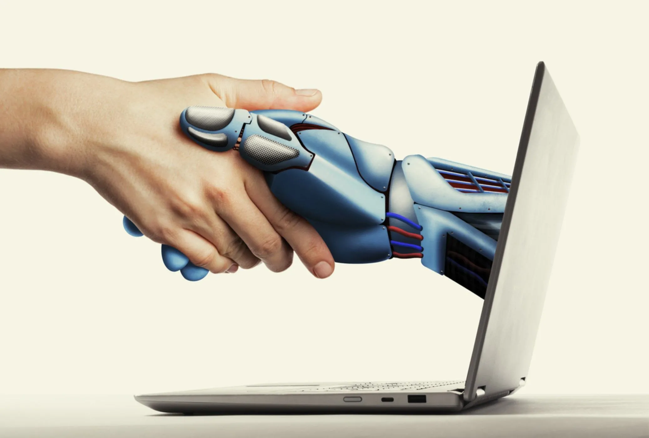 Bàn tay người và bàn tay robot bắt tay nhau, tượng trưng cho mối quan hệ và tương tác giữa con người và trí tuệ nhân tạo