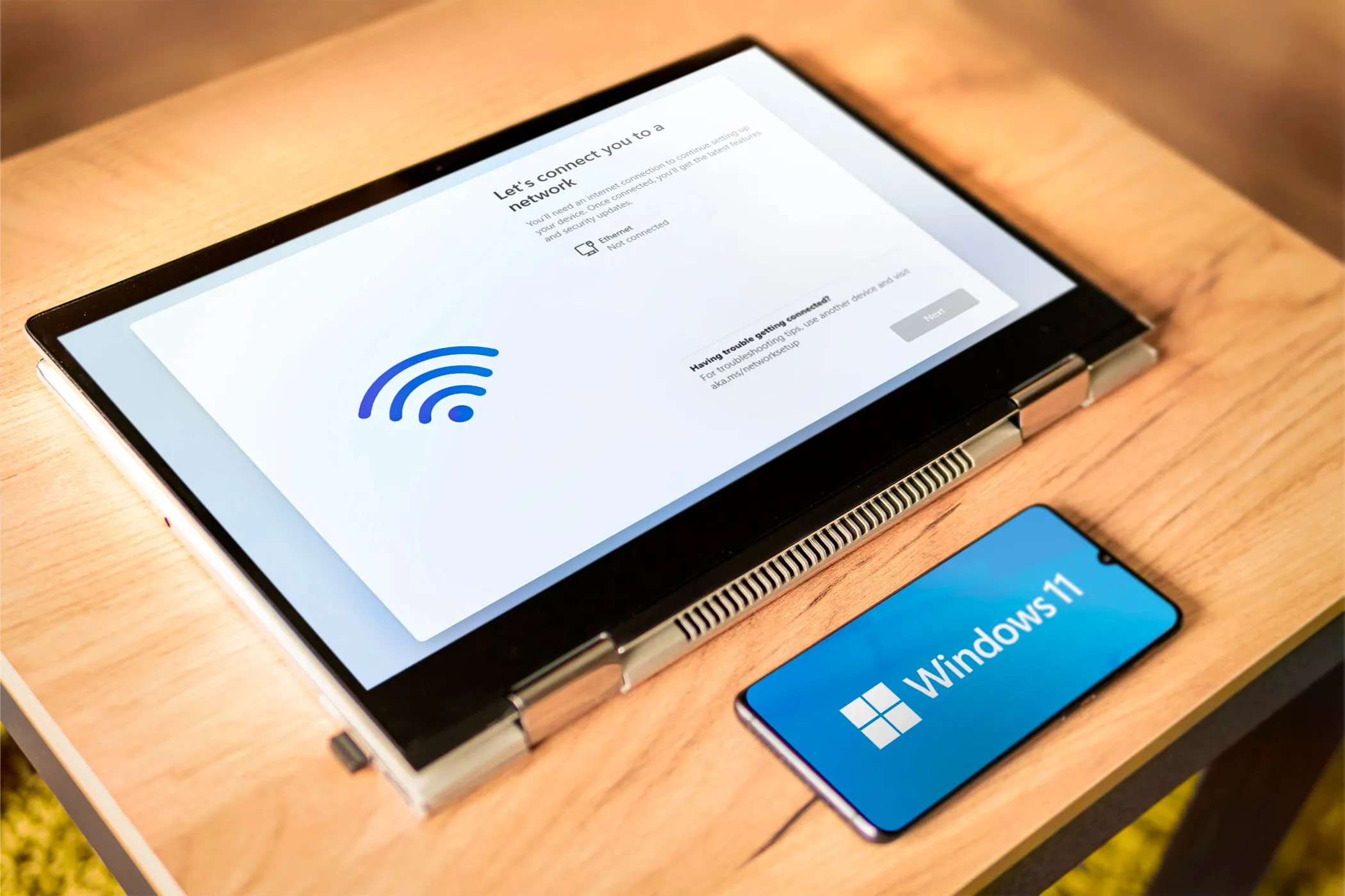 Điện thoại Android đang điều khiển máy tính xách tay chạy Windows 11 từ xa, thể hiện khả năng kiểm soát PC.