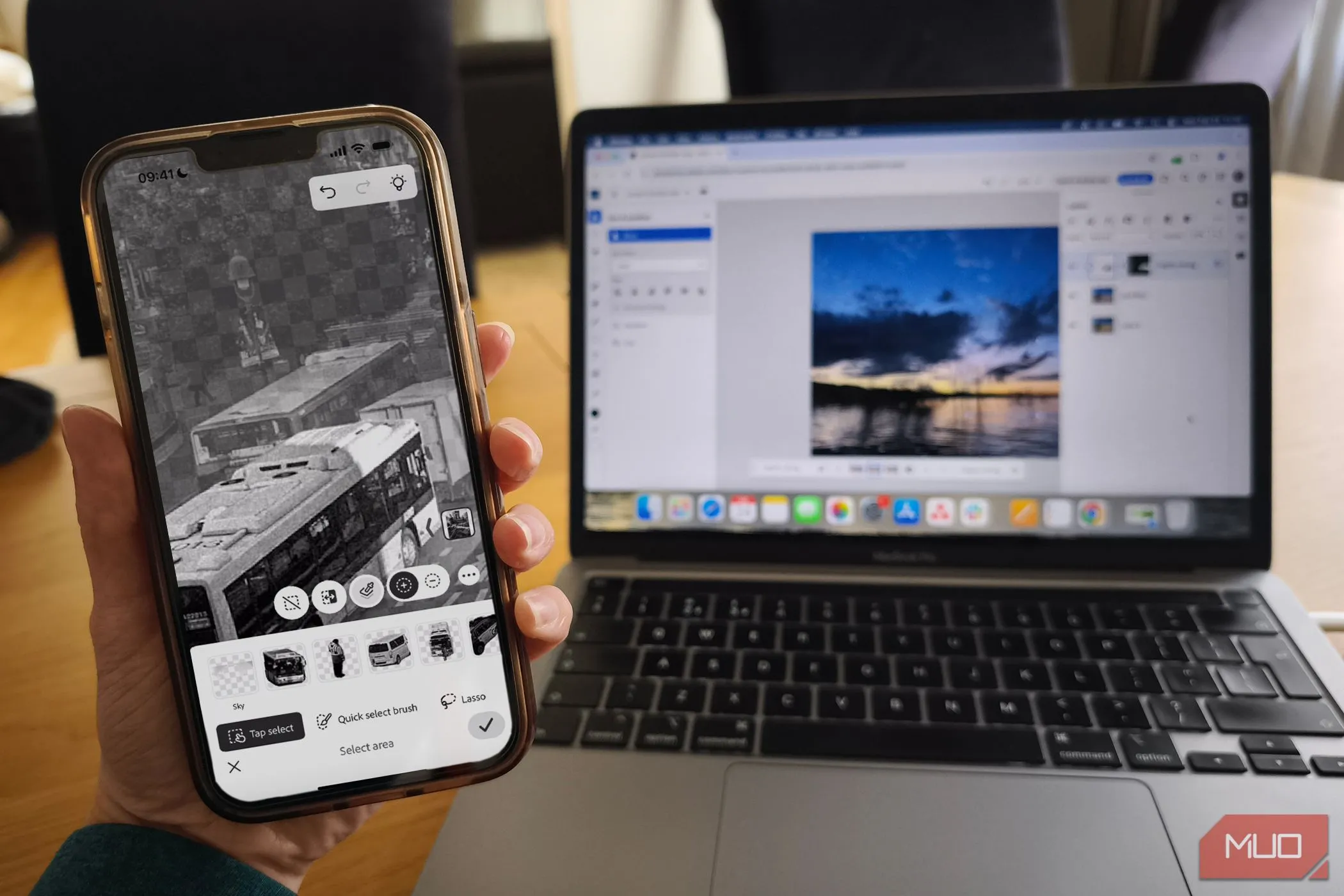Màn hình MacBook hiển thị Photoshop Mobile và Photoshop Web App, minh họa khả năng đồng bộ hóa và làm việc linh hoạt giữa các nền tảng.