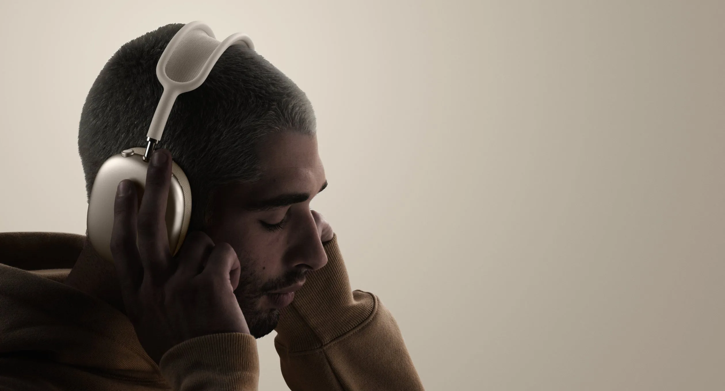 Một người đang đeo tai nghe AirPods Max, minh họa cho thiết kế sang trọng nhưng đồng thời cũng làm nổi bật trọng lượng nặng của thiết bị khi sử dụng lâu.