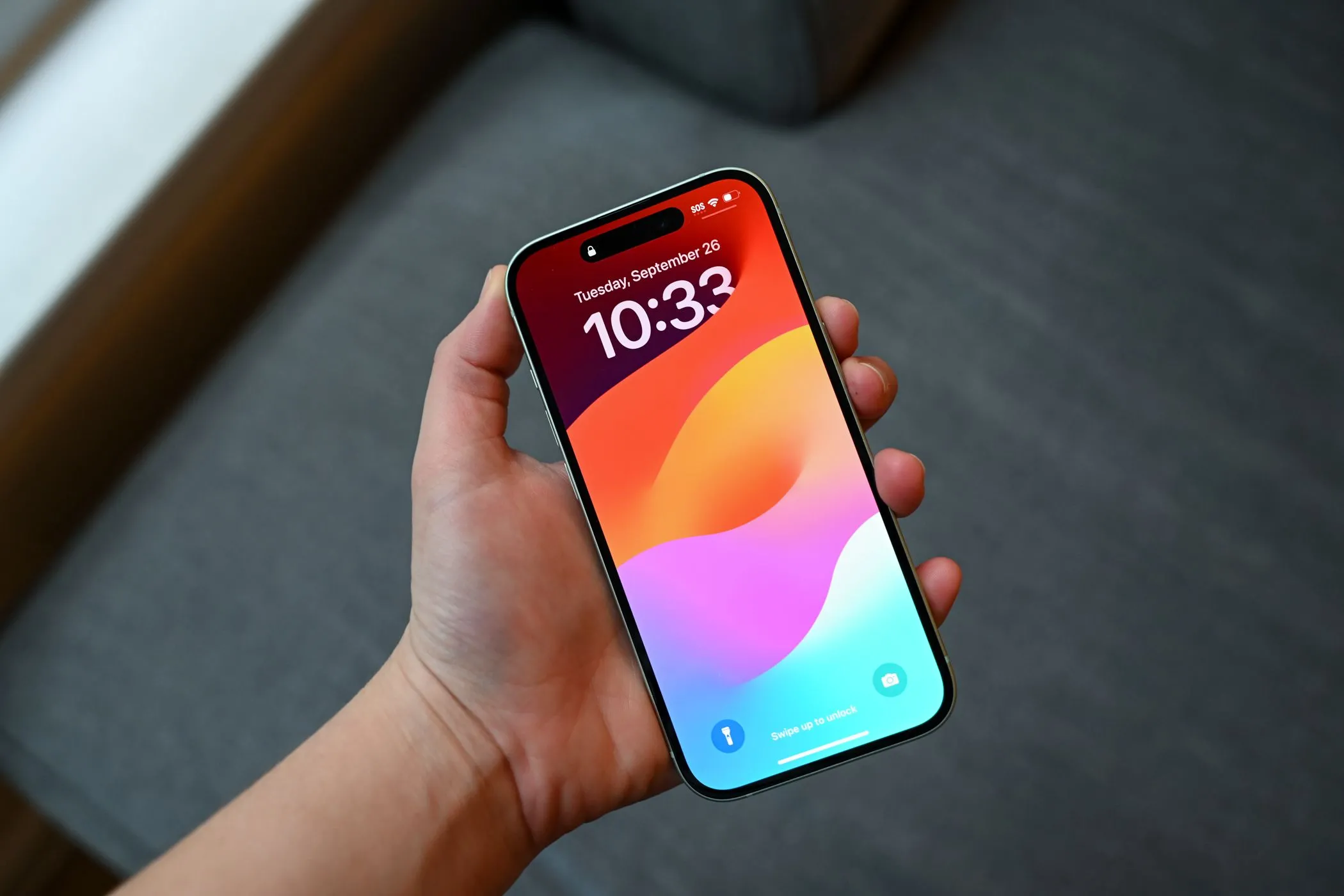 Người cầm iPhone 15 đang ở màn hình khóa